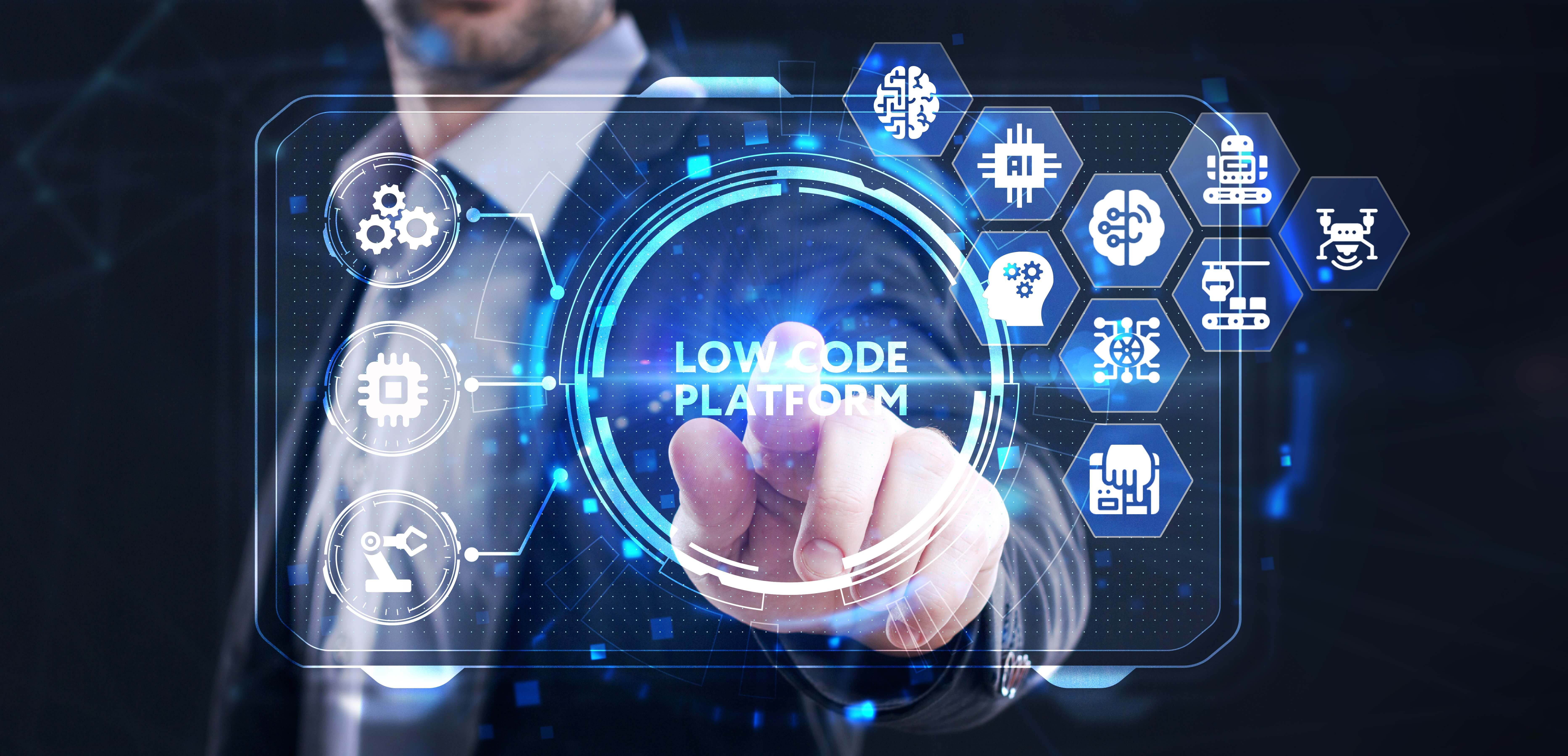 Businessman reaches out to touch Low Code button on a screen full of icons