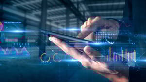 Hands holing and working a tablet, overlaid with charts Hands holing and working a tablet, overlaid with charts