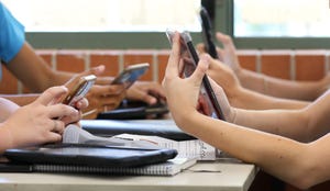 Students' hands holding mobile devices