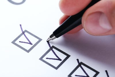 List of checkboxes and a pen marking them off