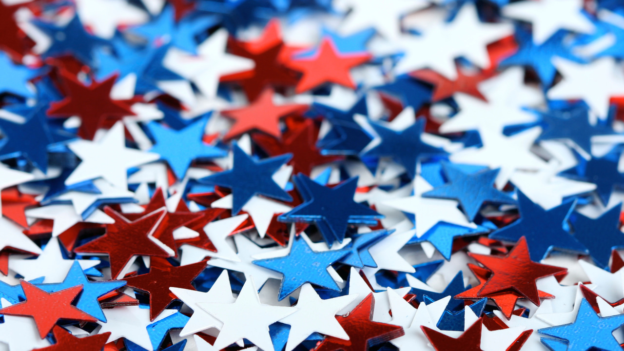 Red, white and blue stars of confetti in a random pile Red, white and blue stars of confetti in a random pile