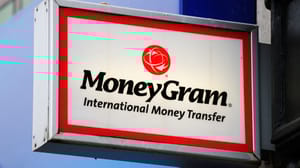 A red and white MoneyGram sign attached to a building A red and white MoneyGram sign attached to a building