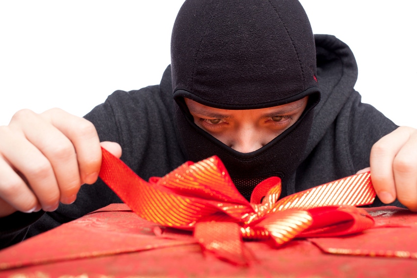 Thief tying a bow on a Christmas present