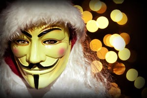 Photo of someone dressed in a Santa Claus costume and wearing a Guy Fawkes / Anonymous mask