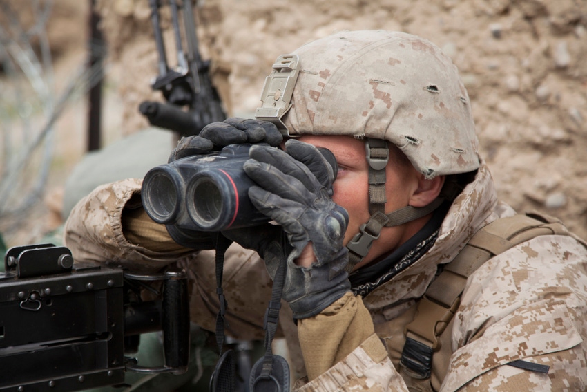 photo of a Marine peering through binoculars