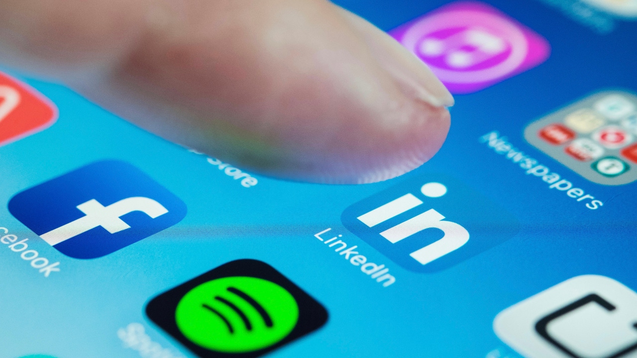 A person's finger about to click on the LinkedIn app on a phone A person's finger about to click on the LinkedIn app on a phone