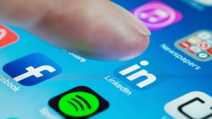A person's finger about to click on the LinkedIn app on a phone A person's finger about to click on the LinkedIn app on a phone