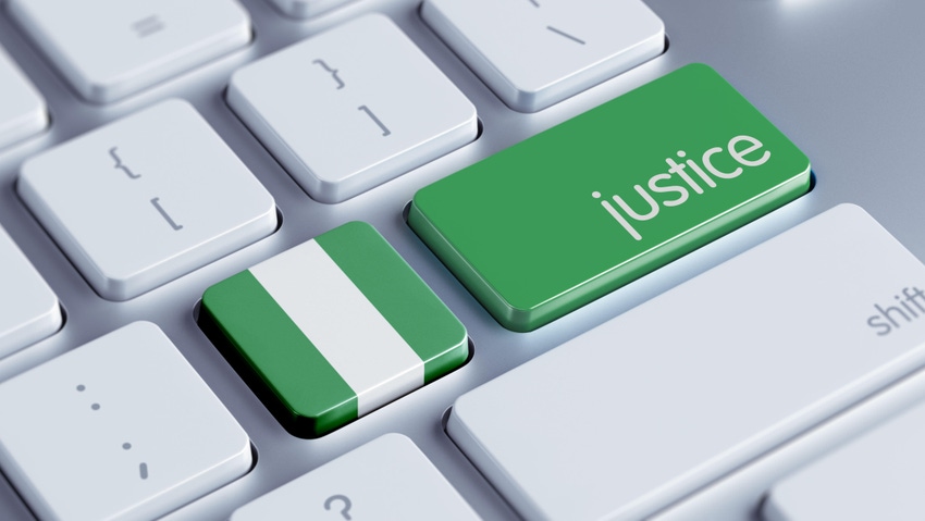 A keyboard with the Nigerian flag and justice on a green key