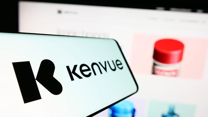 Mobile phone with logo of American consumer health products company Kenvue Inc. in front of website