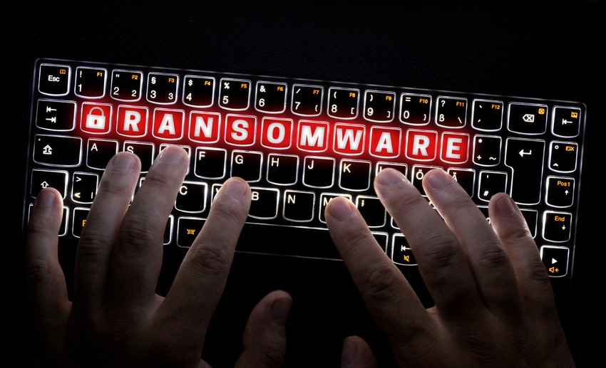 Image shows a keyboard with hands typing at it and the keys spelling out "ransomware" in red and white highlighted letters