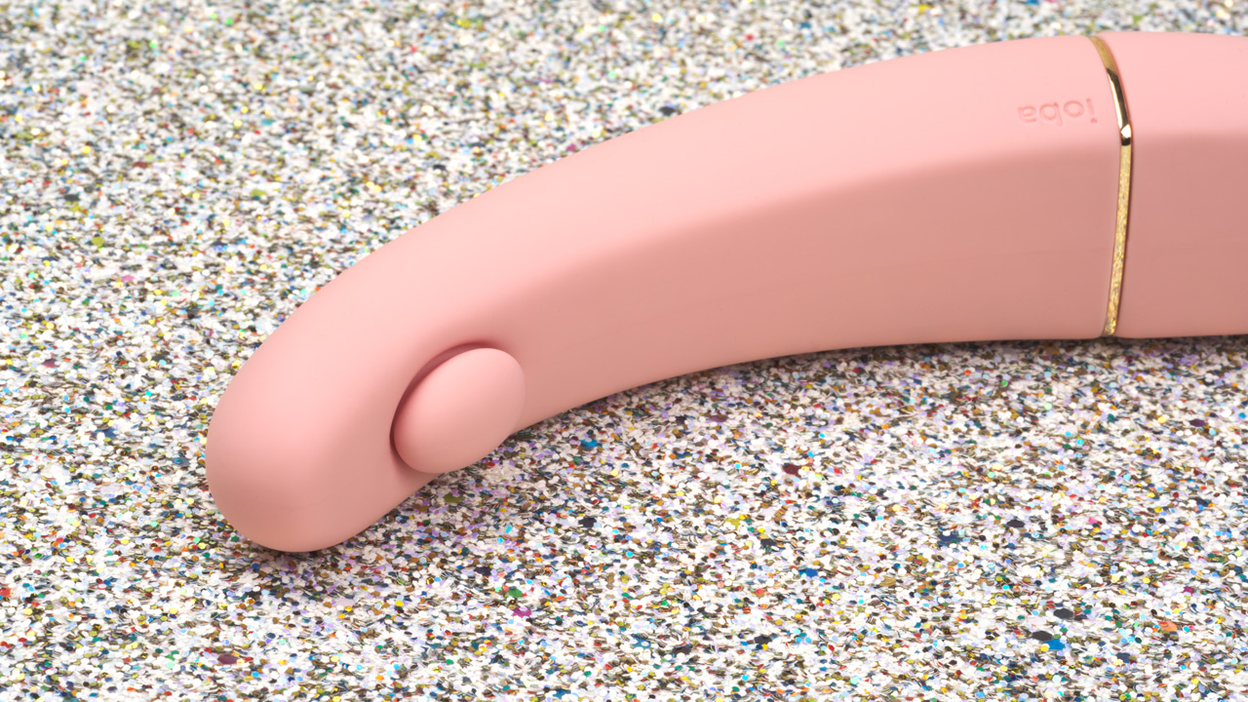 pink G-spot vibrator on glitter background