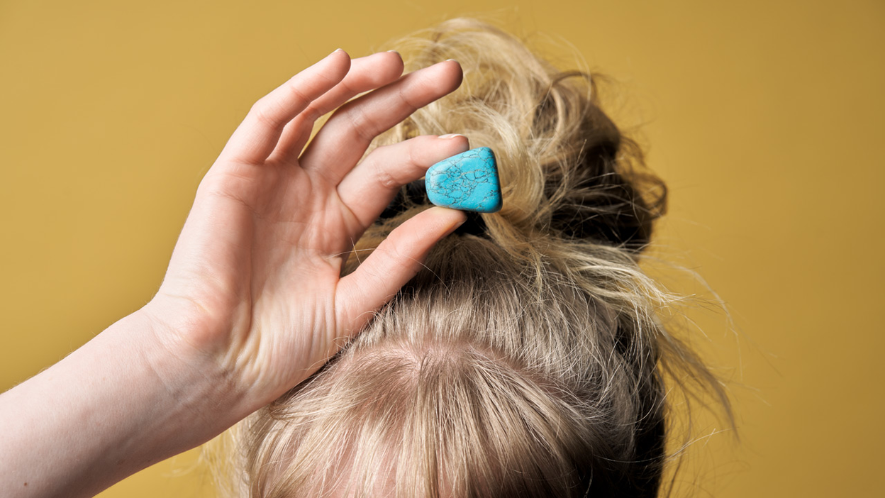 Vrouw houdt een steen boven haar hoofd