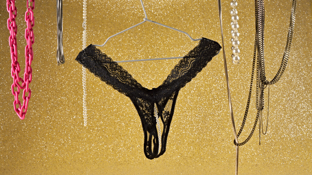 Black panty with pearls hanging on a hanger