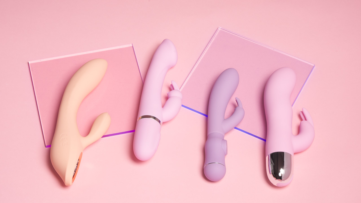 Vier rabbit vibrators in felle kleuren naast elkaar op een roze achtergrond