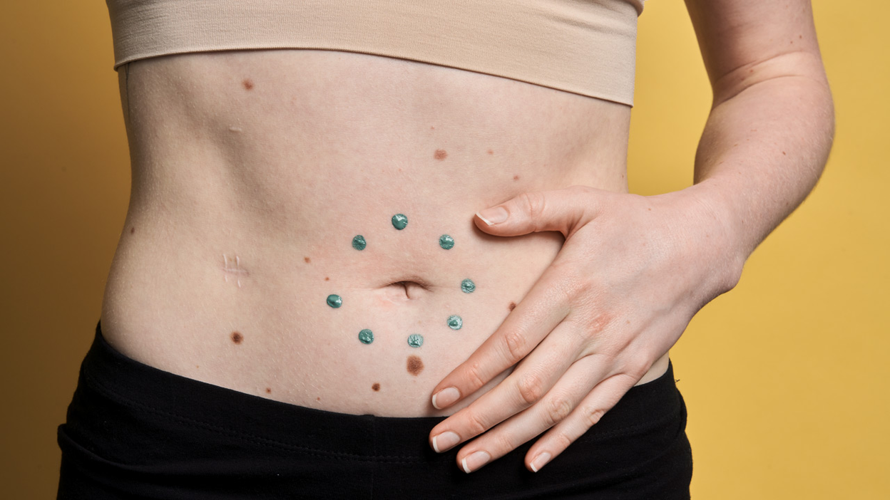 Woman holding her hand on her stomach