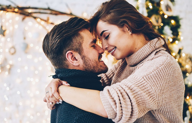 Woman hugging a man while they look in each other's eyes