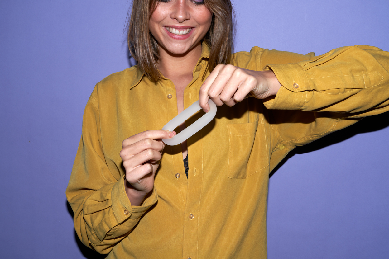 A woman stretching a cock ring