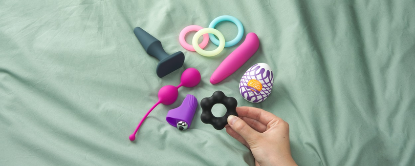 Various sex toys are laying in a pile