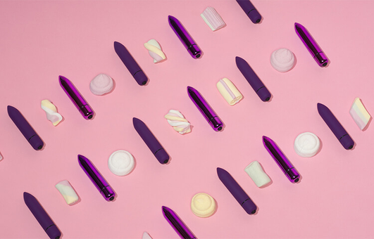 Dildos and marshmallows on a pink background