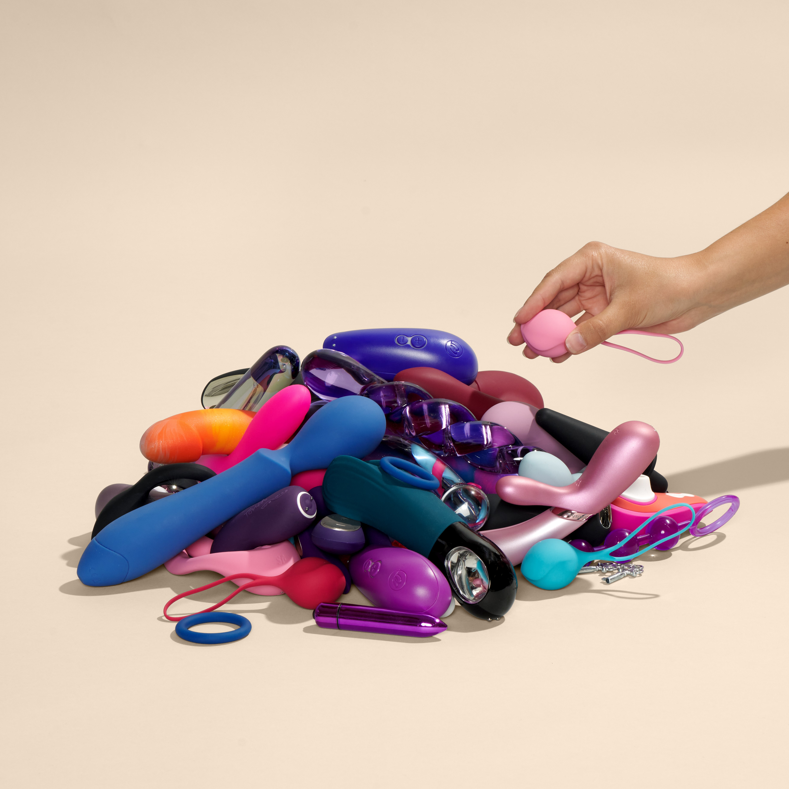 Various sex toys are laying in a pile