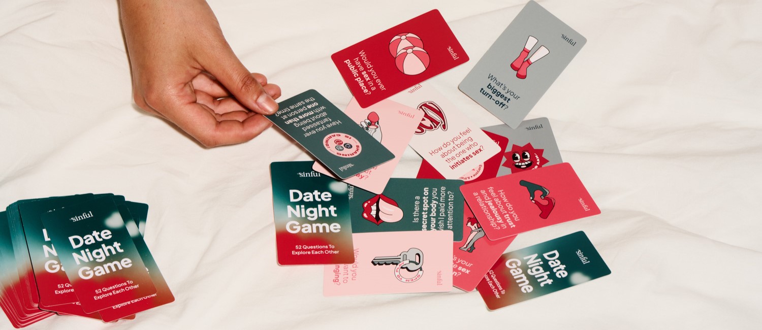 Bunte Fragekarten auf einem weißen Bett.