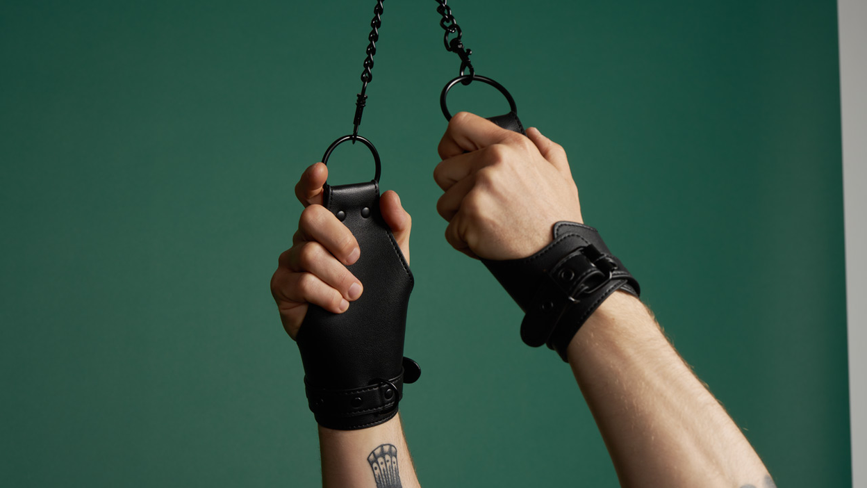 Hands with a set of cuffs around the wrists