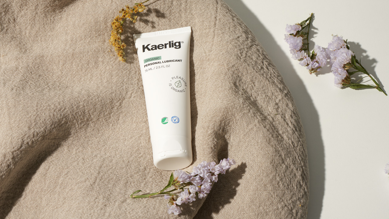 White tube of lube from Kaerlig with flowers on a rug