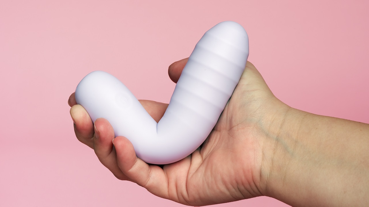  White piece of sextoy in a hand