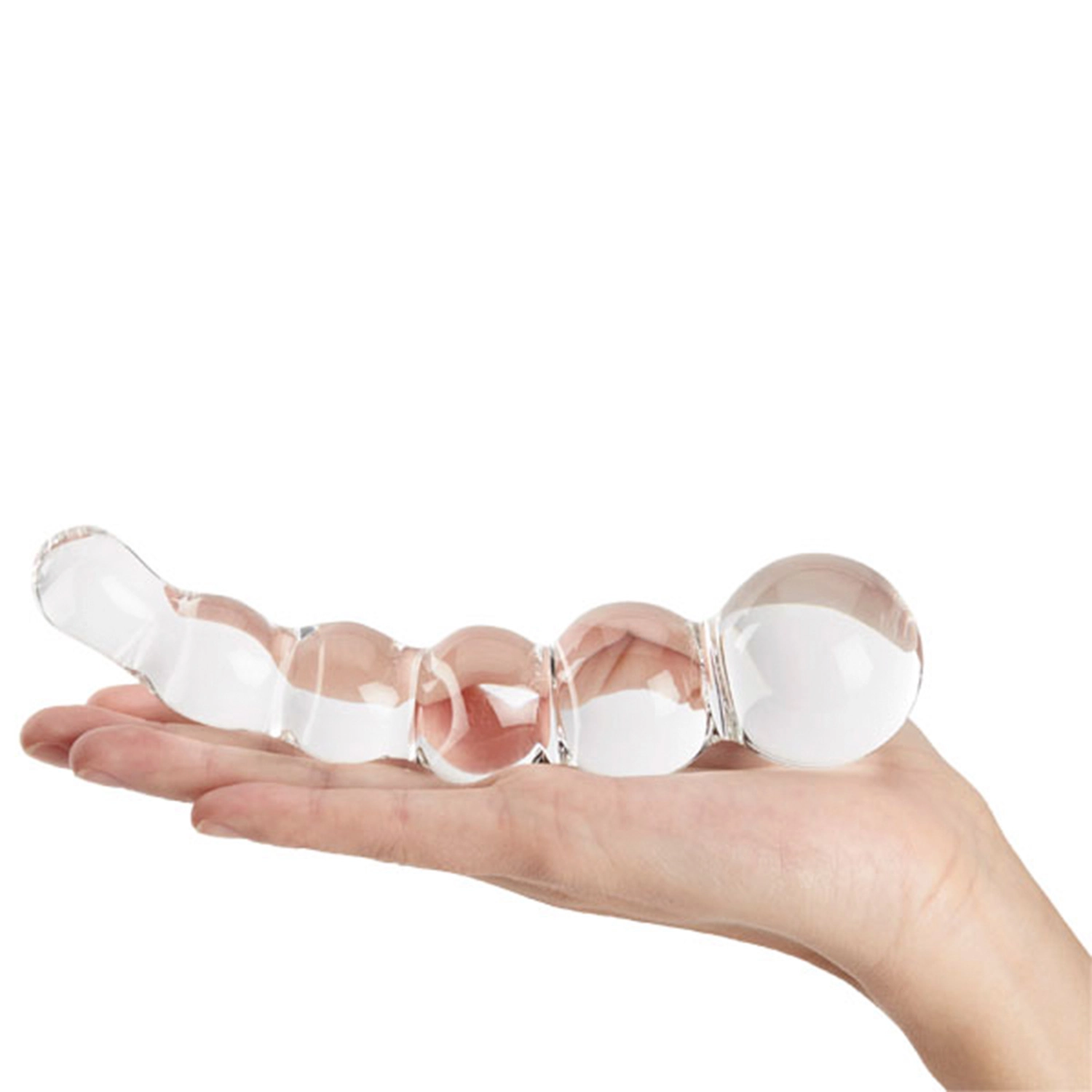 Sinful Groove glassdildo som ligger i håndflaten til en person