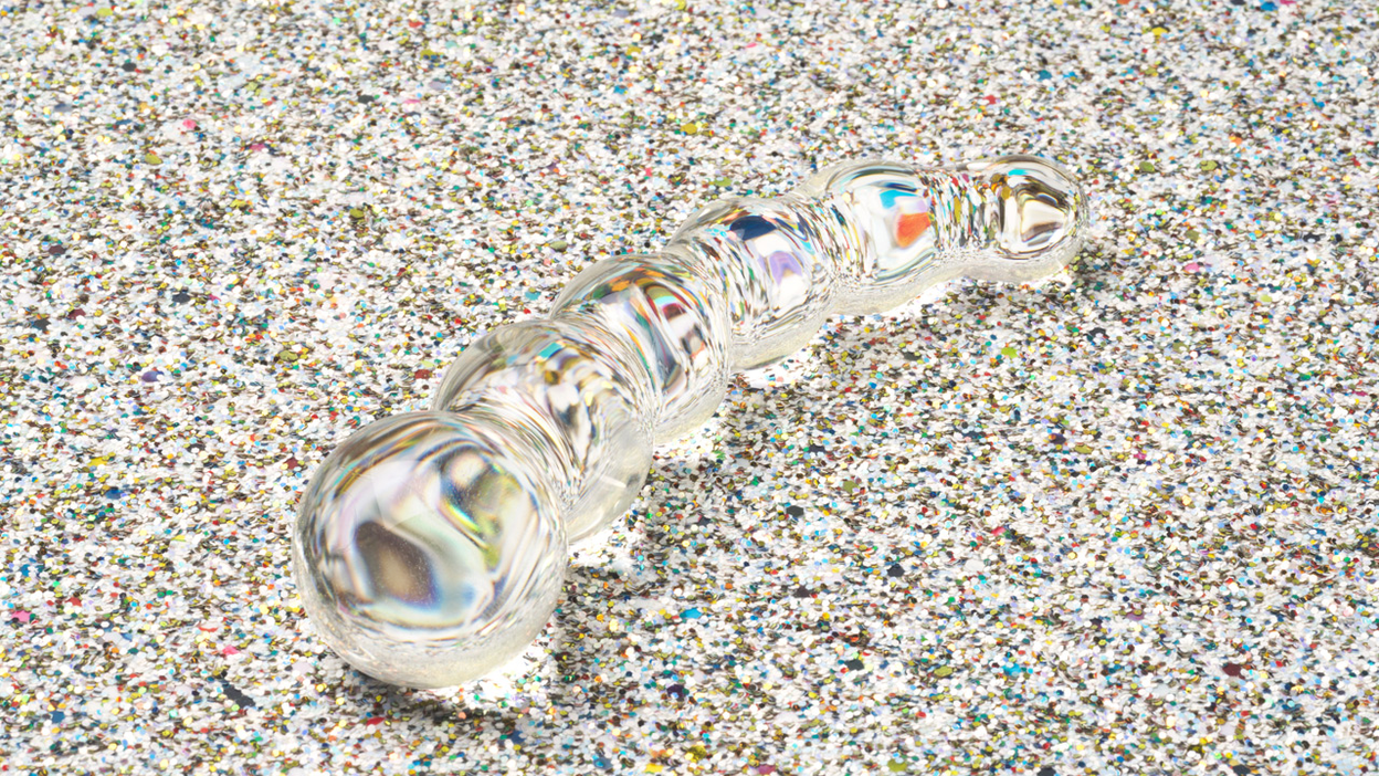 glass dildo with bulb design on glitter background