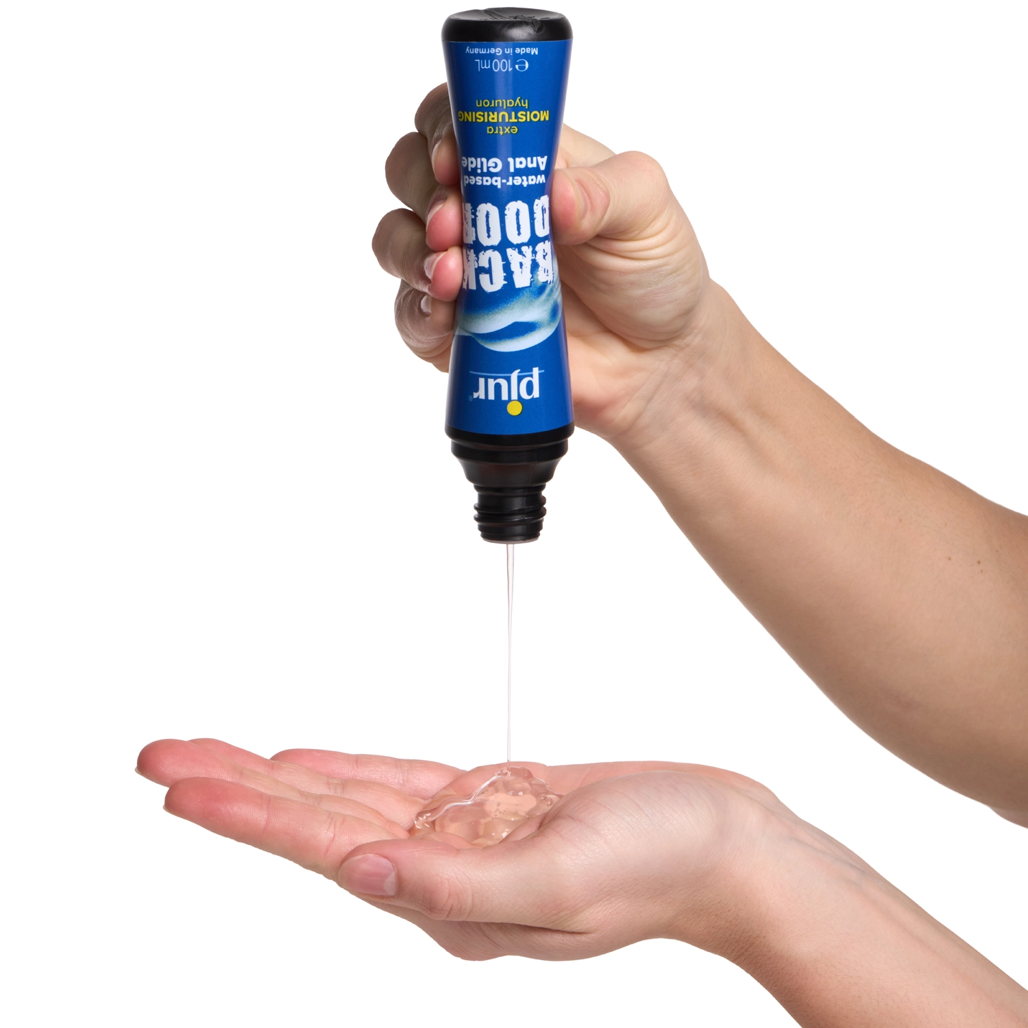 A hand squeezing lube out of a container