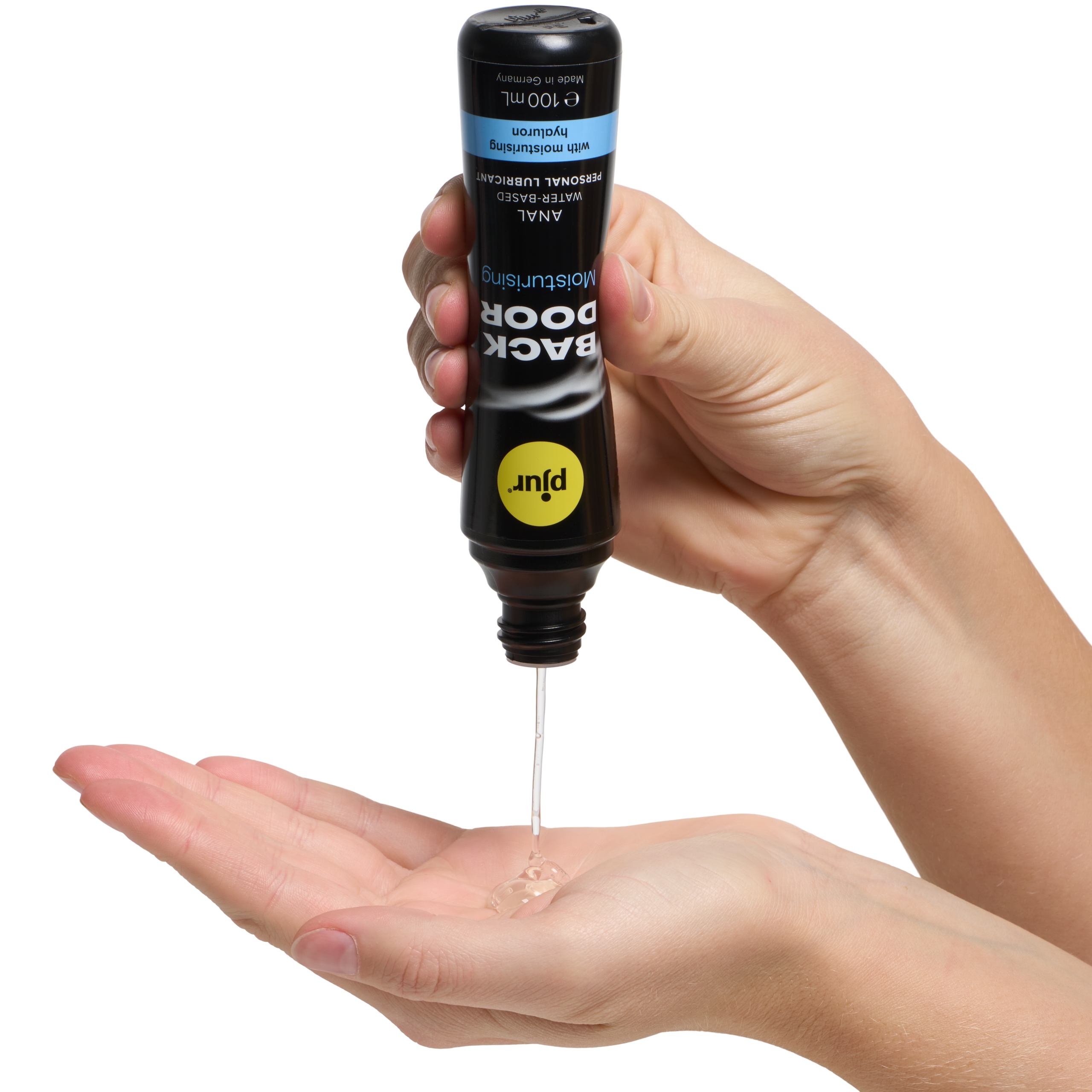 A hand squeezing lube out of a container