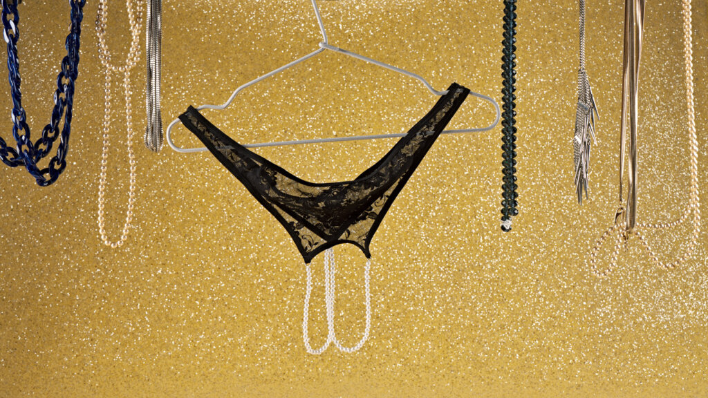 Black panty with pearls hanging on a hanger