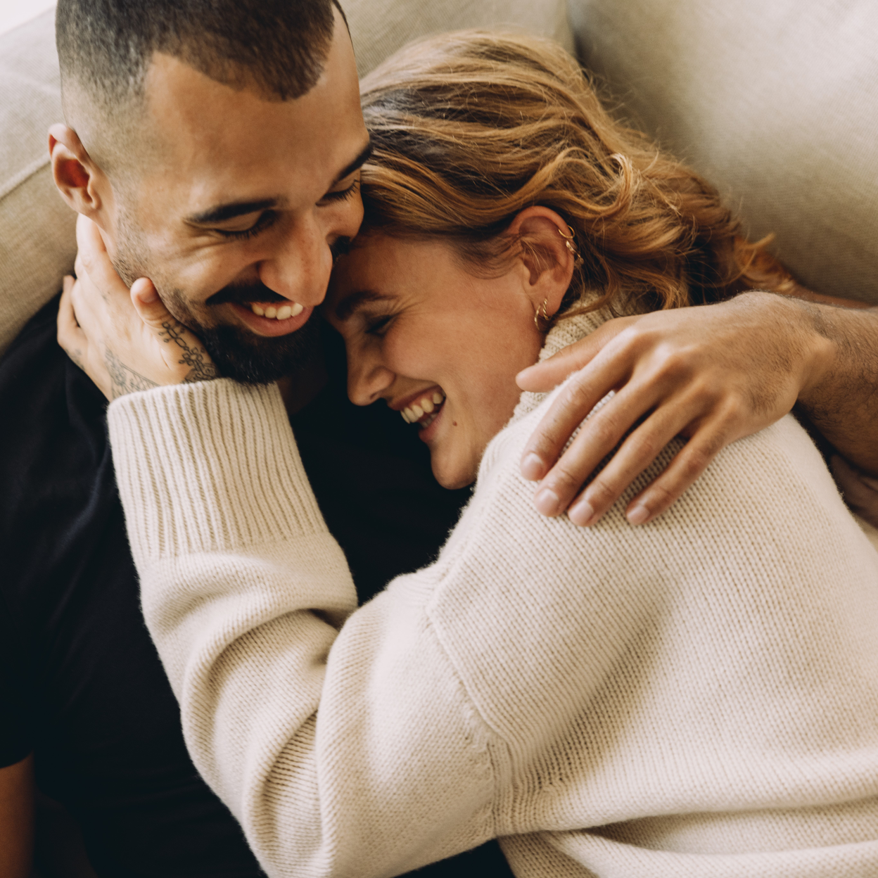 two people cuddling and smiling