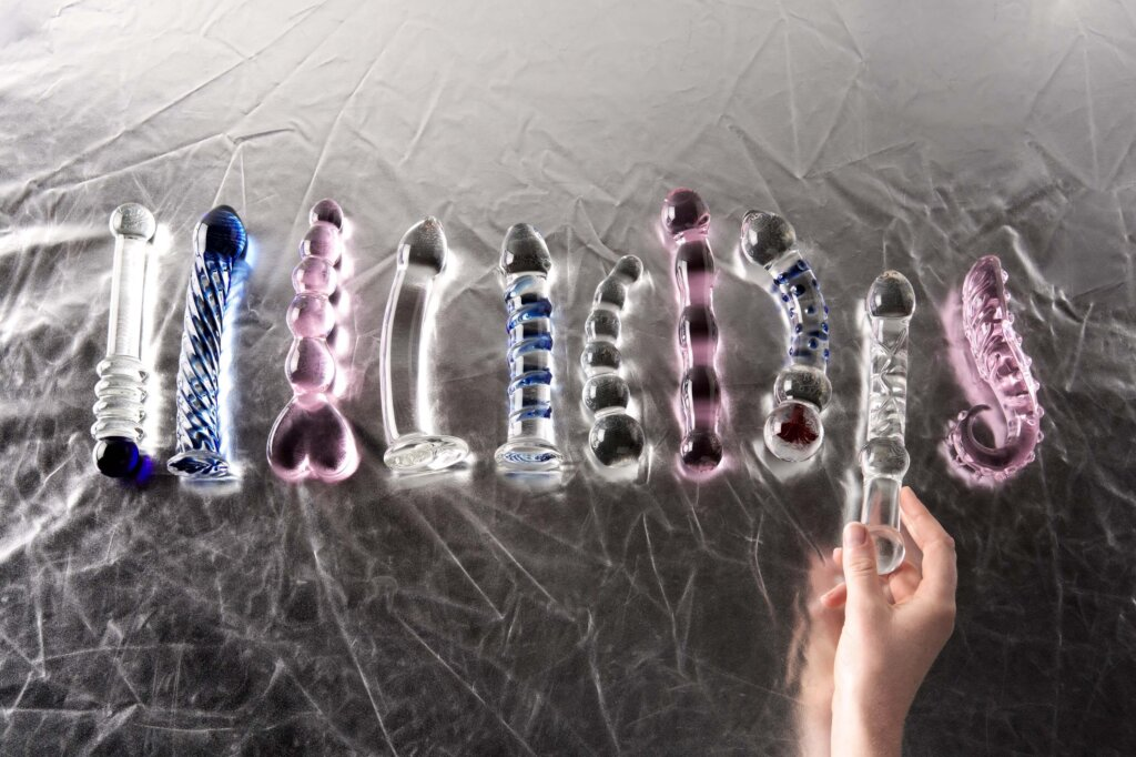 Several coloured glass dildos lined up