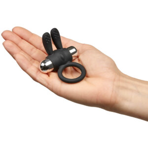 Hand holding a cock ring with vibrator