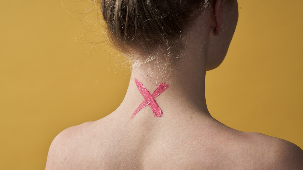 Red cross on the neck of a woman