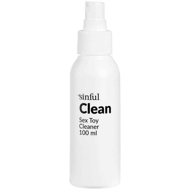 Hvid sprayflaske med klar hætte og sort tekst Sinful Clean Sex Toy Cleaner 100 ml, på hvid bund