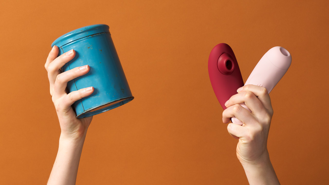 Hands holding two clitoral stimulators and a blue can