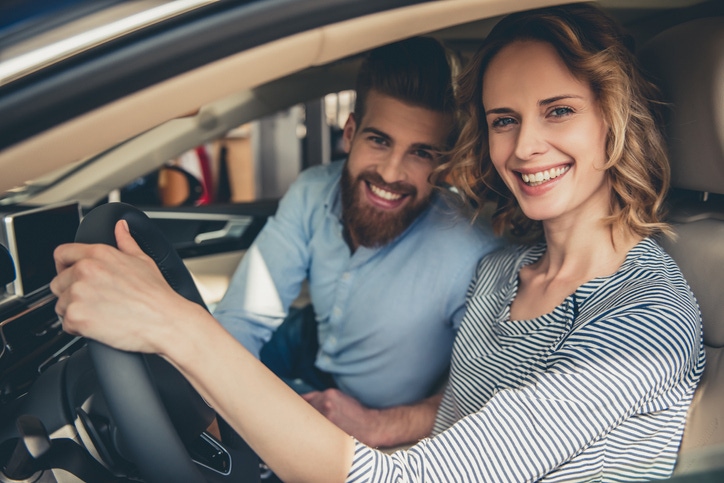couple with new car couple with new car