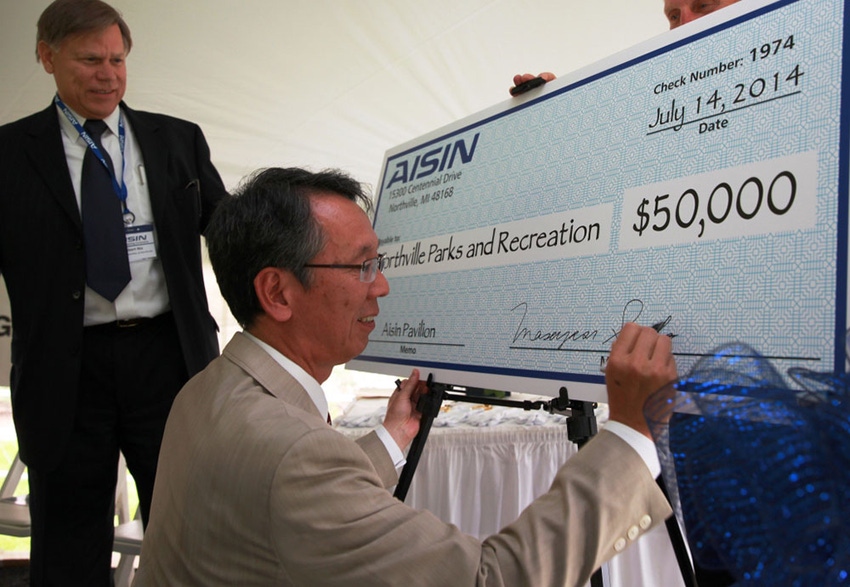 As part of headquarters opening ceremony Aisin World Corp of America CEO Mike Saito presented 50000 gift to Northville Township Parks amp Recreation