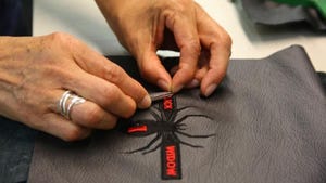 Stitcher works on spider design at Katzkin factory.