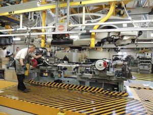 Worker supervises automated marriage of Continental coupersquos chassis and powertrain to body