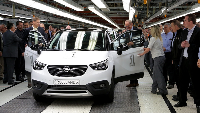 Opel President and CEO Neumann center right OpelVauxhall vice presidentmanufacturing Kienle prepare to drive first Opel Crossland X off assembly line