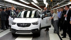 Opel President and CEO Neumann center right OpelVauxhall vice presidentmanufacturing Kienle prepare to drive first Opel Crossland X off assembly line
