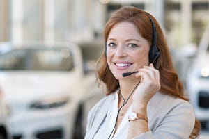 Car salesperson on phone (Getty)