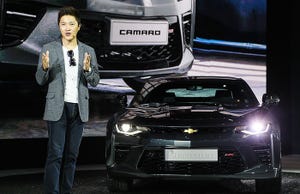Jaemo Ahn Chevrolet racing team member with Camaro at Busan auto show