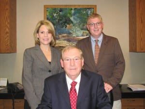 Dealer W Foster Walker III flanked by son Foster Walker IV and daughter Amy Walker Searcy