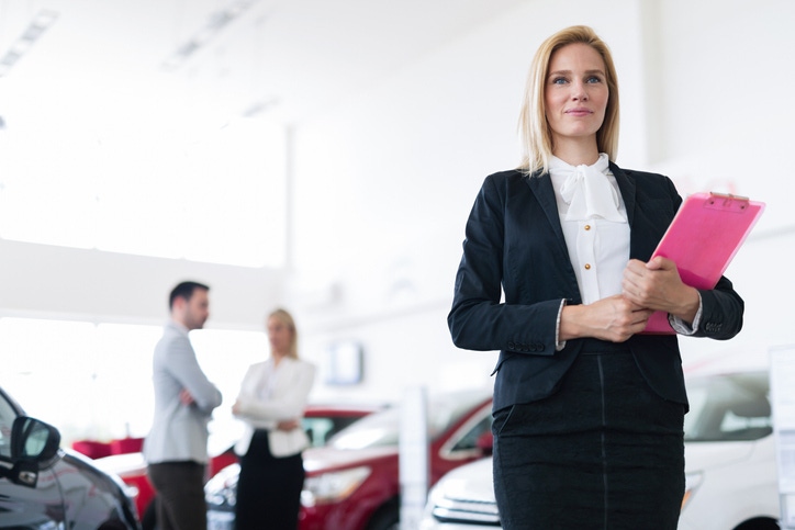 dealership employee with clipboard