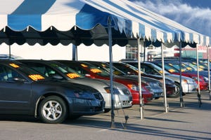 car dealership tent and cars